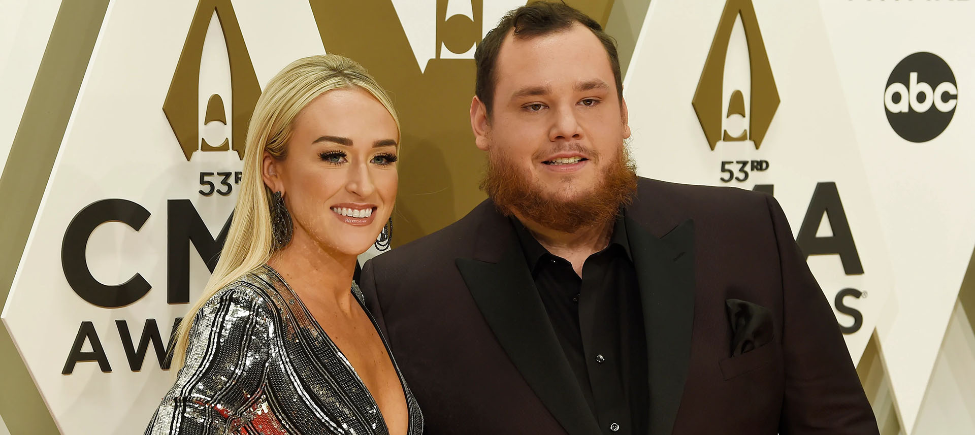Luke Combs and wife posing at the CMT Awards